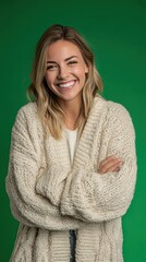 Obraz premium Woman in a cozy sweater, smiling, white teeth, solid green screen background