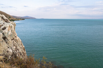 Fototapeta premium The sea is shown with clear water and a rocky shore