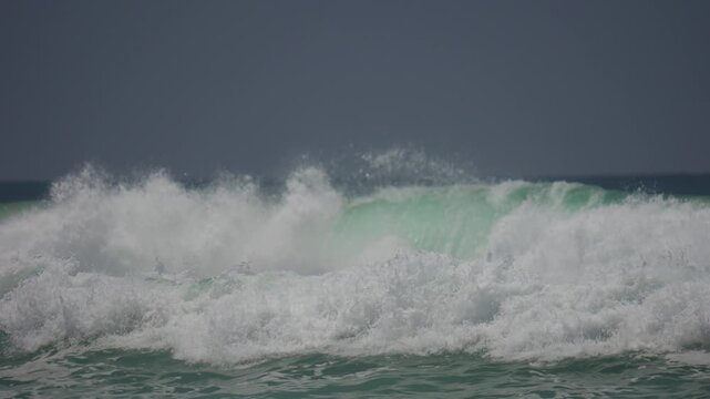 Surfer doing a 180 
air on a wave