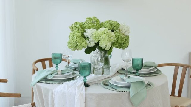 Beautiful place setting with floral decor on table indoors, camera moving right
