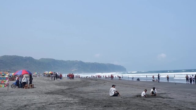 The bustling atmosphere at the sandy Parangtritis Beach in Yogyakarta.