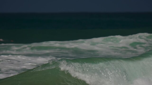 Surfers catching waves on the beach in Huntington