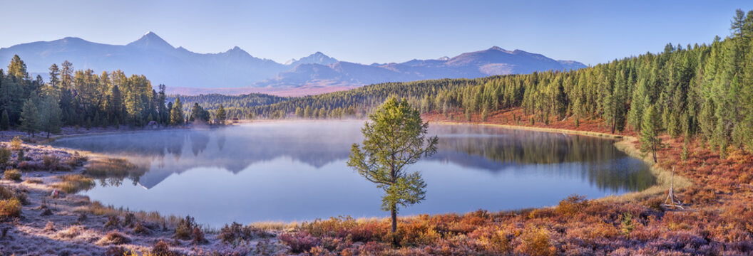 Mountain lake on an autumn morning, forest shores, picturesque reflection in the water