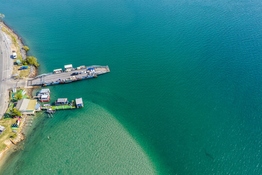 Aerial view of the Settlement Point Ferry crossing the Hastings River in Port Macquarie, connecting Settlement Point with the northern side of the river amid the scenic waterways and coast
