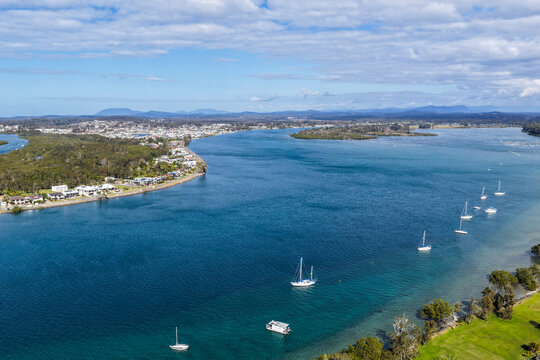 Aerial view of Foreshore Park at Settlement Point in Port Macquarie, featuring the waterfront reserve, surrounding greenery and scenic waters of the Hastings River on the Mid North Coast 