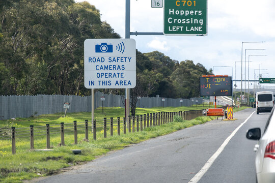 Australian road safety camera advisory sign along a freeway exit to Hoppers Crossing, notifying drivers of camera enforcement in the area. Concept of deterrence and traffic awareness