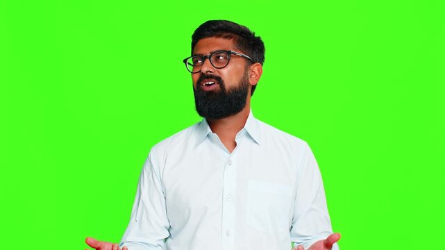 Indian man sighs with visible fatigue slight frustration, expressing dissatisfaction routine or repetitive tasks. Arabian guy isolated on green chroma key background showing emotional boredom stress