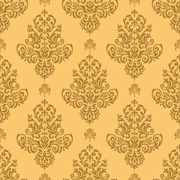 Elegant vintage damask pattern with ornate floral motifs in warm golden brown on a soft yellow background, creating a luxurious classic wallpaper texture.