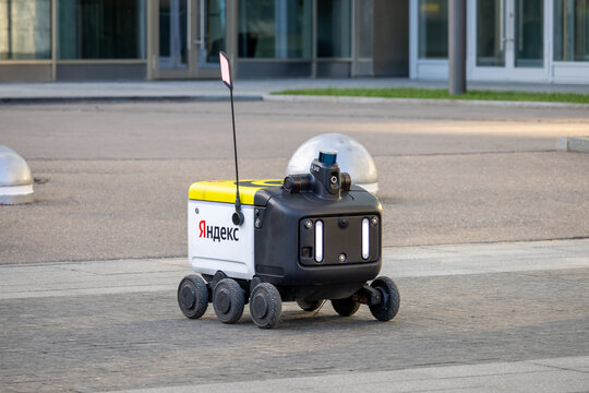 Yandex delivery robot on a street. Small autonomous rover with six wheels and sensors stands outdoors. Moscow, Russia - June 22, 2024