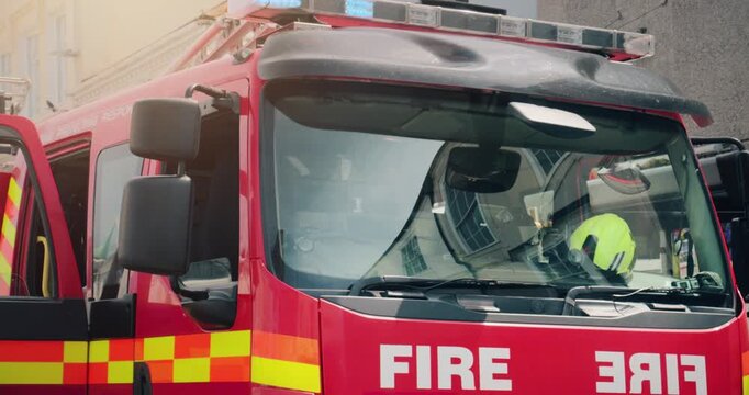 Fire truck emergency service vehicle with flashing lights. Red fire engine with ladders, firefighting apparatus and water to save lives, extinguish fires and assist vehicle collision.