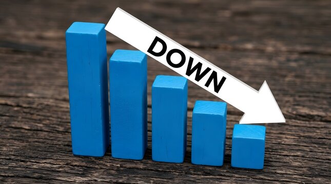 Blue wooden blocks forming a descending bar chart with a white arrow pointing down on wooden background