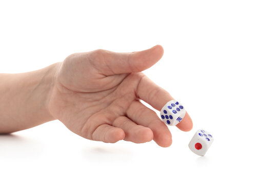 Female hand throwing two game dices on white background