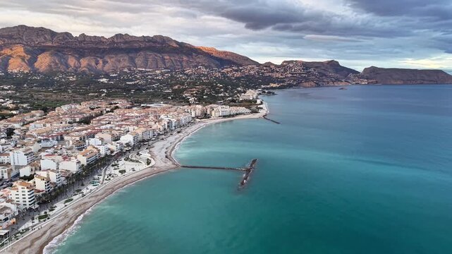 Birdseye crescent bay pier townscape sunrise, cinematic drone sweep across curved shoreline, turquoise water