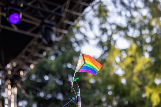BiSexual Gay Pride Flag Pinned to a Drumset on a Stage at an outdoor venue for a concert