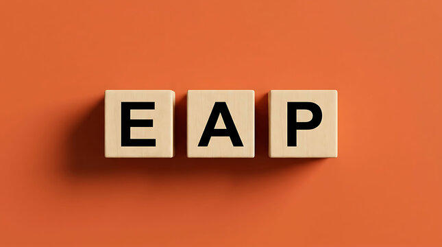 Wooden blocks forming EAP text acronym on orange background
