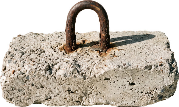 Heavy rectangular concrete block with a rusted metal U shaped lifting anchor eyelet embedded on top showing weathered industrial texture and coarse aggregate structure details