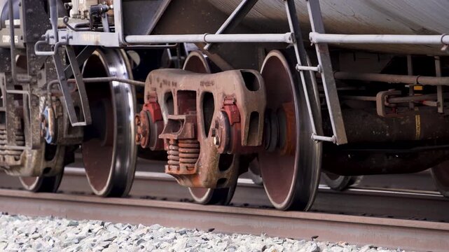 Close up view of the train wheels and axles moving down the tracks through Utah.
