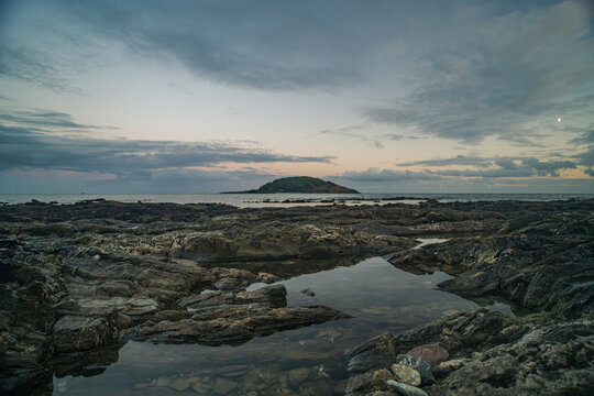 Looe Island seascape at dusk with dramatic clouds over the sea in Cornwall