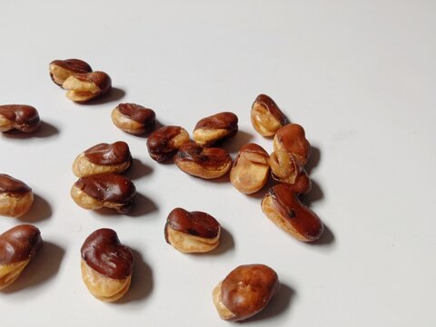 close up of cashews, Roasted cashews scattered on White Background