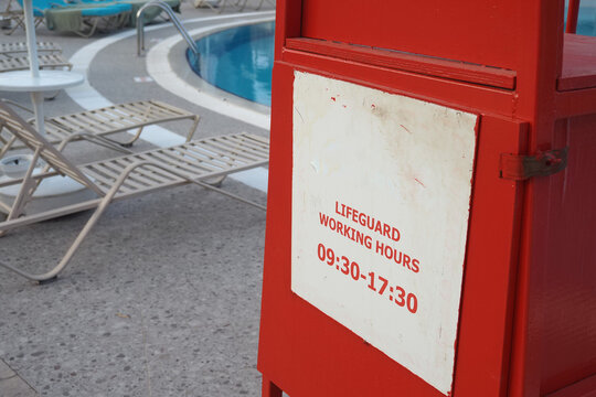Lifeguard working hours sign near the pool