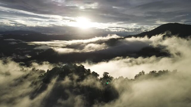 Mountain Sunrise Above Cloud Forest, Dramatic Sunlight Over Misty Valley, Layered Ridge Beneath Moody Sky, Peaceful Landscape Panorama With Serene Natural Atmosphere