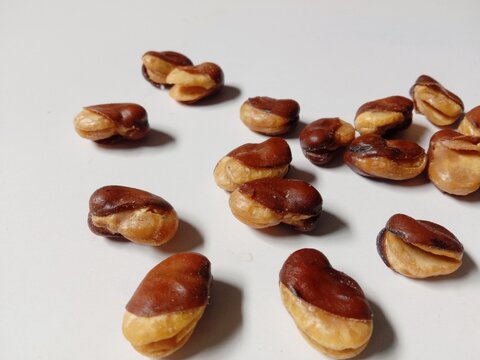 close up of cashews, Roasted cashews scattered on White Background