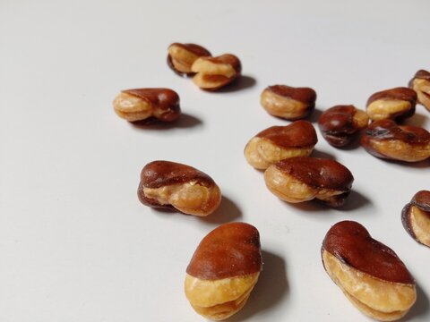 close up of cashews, Roasted cashews scattered on White Background