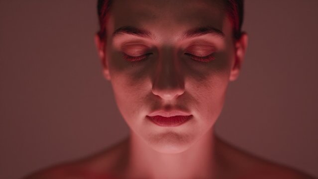 Serene Close-Up of a Calm Woman with Eyes Closed and Soft Lighting