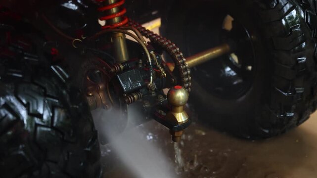 Off Road Vehicle Suspension, Tire, Undercarriage, Chain Drive, Wheel, Water Spray, Wet Terrain, Mechanical Detail, Motorcycle Tread Cleaning, Rugged Outdoor Maintenance Engineering