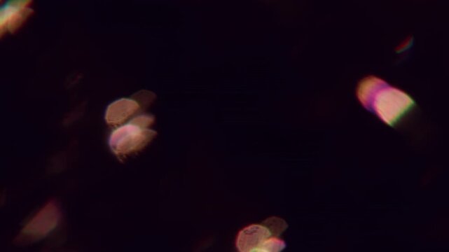 Optical light. Blur flare gleam. Defocused yellow color glow flicker blaze lens glimmer shine on abstract bokeh effect dark black art background.