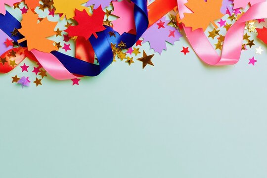 Colorful satin ribbons and maple leaf cut-outs with gold star confetti on a pale background, featuring a glossy sheen for patriotic cards and festive banners with copy space