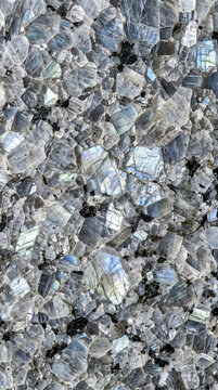 Photorealistic extreme macro texture completely covered with polished anorthosite rock, featuring interlocking grey mineral crystals, labradorite-like iridescent blue flashes, and dark mineral inclusi