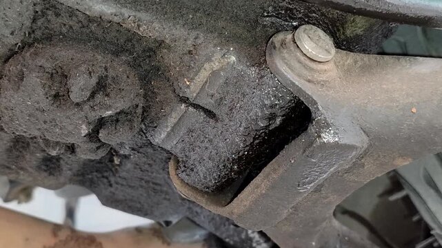 Leaking motorbike oil seeps into the bottom of the motorbike