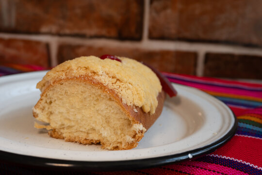 Slice of "Rosca de Reyes" on a bench plate, January 6 celebration