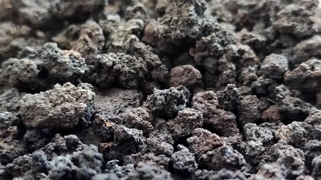 Black volcanic lava stone gravel, natural porous basalt rock texture for aquascape and gardening