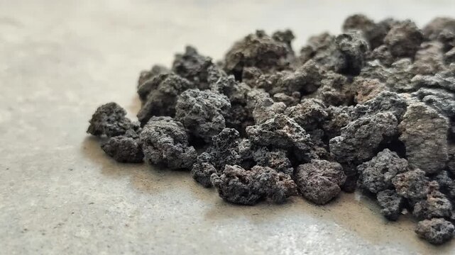 Black volcanic lava stone gravel, natural porous basalt rock texture for aquascape and gardening