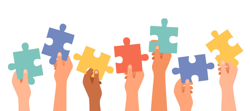 Group of multi-ethnic business people with raised arms holding a piece of jigsaw. Cooperate and collaborate. Concept of teamwork and success