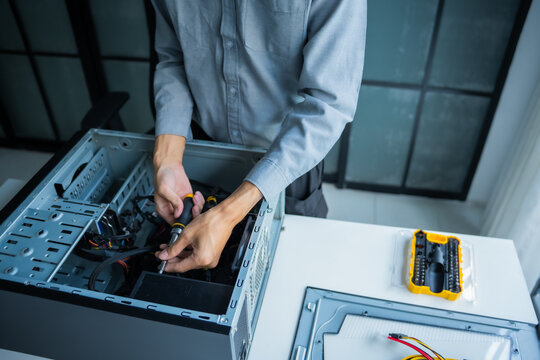 Asian IT engineer using screwdriver fix pc case
