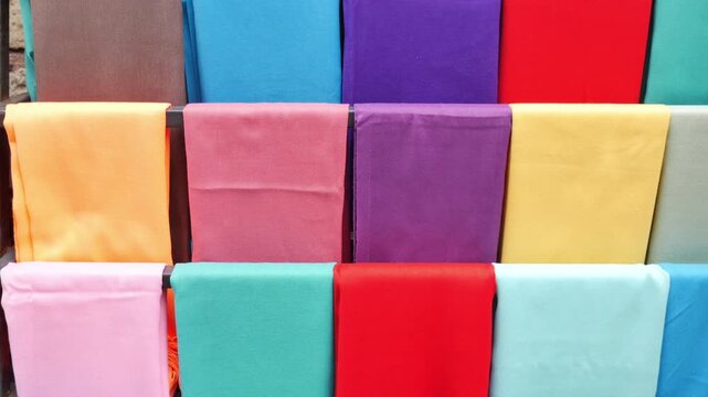 Colorful cloth display at a market in the afternoon