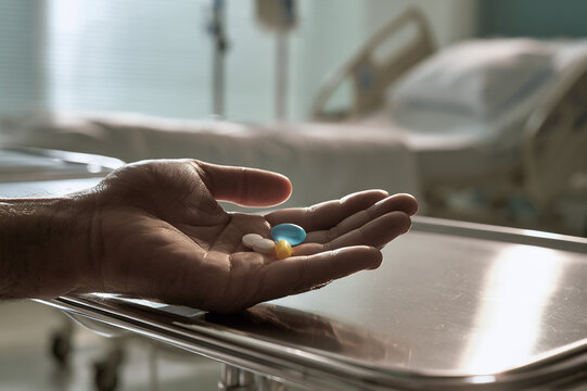open hand holding three daily medication pills