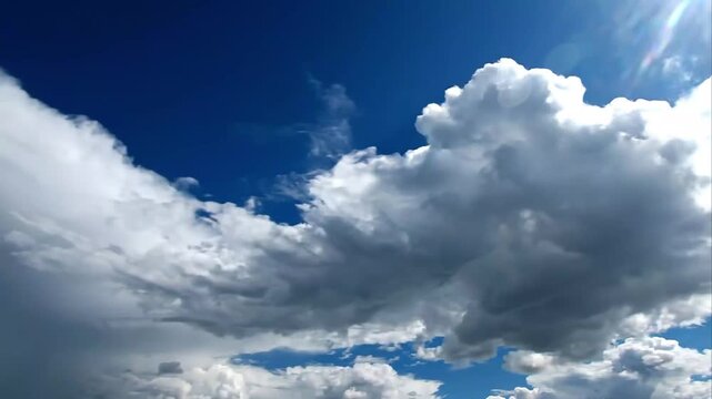 Dramatic White Cumulus Clouds Moving Across Deep Blue Sky Timelapse