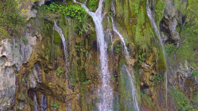 Mountains and waterfalls dreamlike view. The lake mirrors the cascading waterfall. Plitvice waterfalls and lakes. A perfect balance of nature and waterfalls. Waterfalls peaceful landscape.