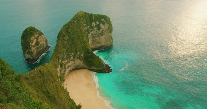 Sunset light hits rock formations at Nusa Penida Island Bali coastline