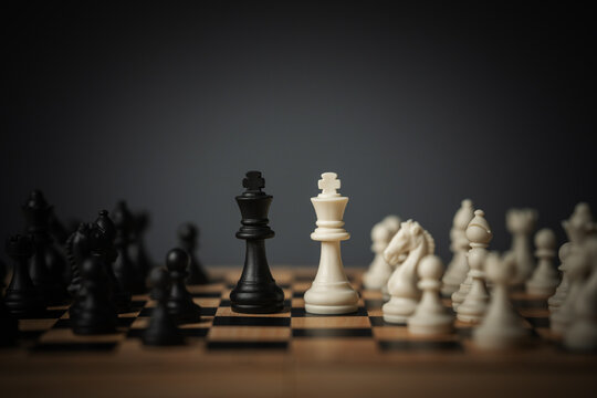 white and black kings facing off on chess board