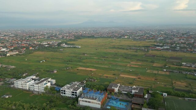 Last Remaining Agricultural Land In Downtown Bali Indonesia Mountains In Distance Drone Shot 4K 60FPS