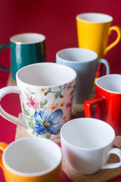 Assorted, colourful mugs and cups with different shapes and sizes. 