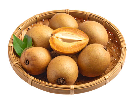 Sapodillas on a woven bamboo plate isolated on transparent png