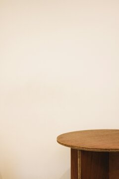 Minimalist Beige Wall Studio Background with Round Table Top Corner View