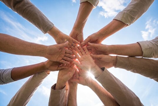 Diverse Group Hands Joined in Circle Unity Collaboration Concept Blue Sky