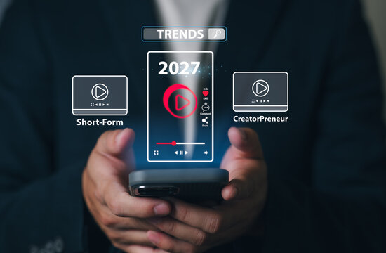 A Person holding a smartphone with a digital display showing upcoming trends Video Short-Form & Creator Preneur in 2027, including media icons, trend labels, and a futuristic interface.